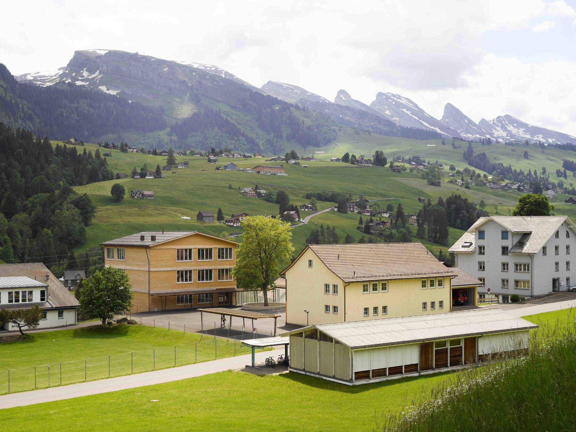 Freistehende Gebäude und sattgrüne Talhänge prägen das Ortsbild Toggenburgs – analog dazu die neue Primarschule Wildhaus.